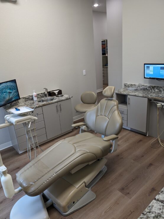 Interior of dental exam room at Cole White Dental with dental chair.